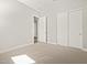 A stylish bedroom featuring neutral carpeting and modern white closet doors at 17636 W Pierson St, Goodyear, AZ 85395