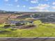 Aerial view of community park with playground, basketball court, green space and new homesites in background at 17636 W Pierson St, Goodyear, AZ 85395