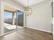 Bright dining area with tile floors, modern chandelier, and sliding glass doors to the backyard patio at 17636 W Pierson St, Goodyear, AZ 85395
