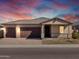 Beautiful single-story home featuring a two-car garage under a gorgeous sunset sky at 17636 W Pierson St, Goodyear, AZ 85395