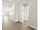 Bright hallway with light wood-look flooring, neutral walls, and white trim at 17636 W Pierson St, Goodyear, AZ 85395