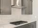 Kitchen features stainless steel range hood, white subway tile backsplash, and gas cooktop at 17636 W Pierson St, Goodyear, AZ 85395