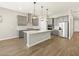 Spacious kitchen featuring gray cabinets, stainless steel appliances and a large kitchen island at 17636 W Pierson St, Goodyear, AZ 85395