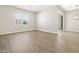 A bright open living room with wood-look tile flooring and modern fixtures at 17636 W Pierson St, Goodyear, AZ 85395