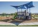 Community playground featuring a modern play structure with climbing features, slides, and shaded area at 17636 W Pierson St, Goodyear, AZ 85395
