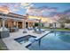 Luxury backyard oasis featuring a pool, spa, and outdoor kitchen at 18391 N 97Th Pl, Scottsdale, AZ 85255