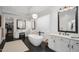 Spa-like bathroom with a freestanding tub, dual vanities, and walk-in closet at 18391 N 97Th Pl, Scottsdale, AZ 85255