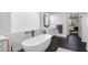 Elegant bathroom with a soaking tub, modern fixtures, and dark tile floors at 18391 N 97Th Pl, Scottsdale, AZ 85255