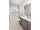 Bathroom with a shower/tub combo, gray cabinets and tile flooring at 18391 N 97Th Pl, Scottsdale, AZ 85255