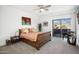 Bright bedroom with wood sleigh bed, mountain views, and private balcony access at 18391 N 97Th Pl, Scottsdale, AZ 85255