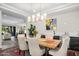 Elegant dining room with a large wooden table and modern chandelier at 18391 N 97Th Pl, Scottsdale, AZ 85255