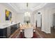 Bright dining room with a custom wooden table and wet bar at 18391 N 97Th Pl, Scottsdale, AZ 85255