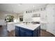 Bright kitchen features a large island, white shaker cabinets, and quartz countertops at 18391 N 97Th Pl, Scottsdale, AZ 85255
