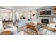 Open living room with fireplace and views to dining and entry at 18391 N 97Th Pl, Scottsdale, AZ 85255