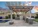 Outdoor kitchen with pergola, perfect for entertaining guests at 18391 N 97Th Pl, Scottsdale, AZ 85255