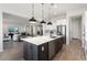 Modern kitchen with a large island, stainless steel appliances, and white cabinets at 20210 N Wagner Wash Dr, Buckeye, AZ 85396