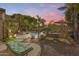 Landscaped backyard with firepit and relaxing seating areas at 2611 W Trapanotto Rd, Phoenix, AZ 85086