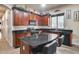 Kitchen boasts dark wood cabinets, granite counters, and an island at 2611 W Trapanotto Rd, Phoenix, AZ 85086
