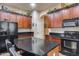 Kitchen features dark wood cabinets, granite counters, and an island at 2611 W Trapanotto Rd, Phoenix, AZ 85086