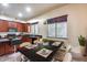 Eat-in kitchen featuring dark wood cabinetry, modern appliances, and a stylish dark countertop at 2611 W Trapanotto Rd, Phoenix, AZ 85086