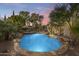 Inviting pool with waterfall feature, surrounded by lush landscaping at 2611 W Trapanotto Rd, Phoenix, AZ 85086