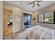 Spacious bedroom with sliding door to patio, a ceiling fan and wood-like flooring at 26475 N 106Th Way, Scottsdale, AZ 85255