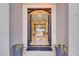 Elegant entryway with arched double doors and decorative lighting at 26475 N 106Th Way, Scottsdale, AZ 85255