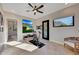 Home gym with an exercise bike, large screen TV, and plenty of natural light at 26475 N 106Th Way, Scottsdale, AZ 85255