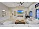 Light and airy living room with a modern fireplace and built-in TV at 26475 N 106Th Way, Scottsdale, AZ 85255