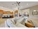 Open living area with a large sectional sofa and views to the kitchen and entry at 26475 N 106Th Way, Scottsdale, AZ 85255