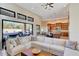 Spacious living room features a large sectional sofa and opens to the kitchen at 26475 N 106Th Way, Scottsdale, AZ 85255