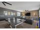 Game room with ping pong table, sectional sofa and wood accent wall at 3022 W Trapanotto Rd, Phoenix, AZ 85086