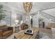 Open living room with a statement chandelier and access to the entryway at 3022 W Trapanotto Rd, Phoenix, AZ 85086