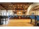 Long bar with dark wood finishes, blue velvet barstools, and wood floors at 3172 S Mulberry Ct, Gold Canyon, AZ 85118