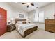 Bedroom with wooden dresser, large bed, and ceiling fan at 3172 S Mulberry Ct, Gold Canyon, AZ 85118