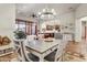 Bright dining room with a farmhouse table and chandelier, adjacent to the kitchen at 3172 S Mulberry Ct, Gold Canyon, AZ 85118