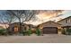 Charming single-story home featuring a beautiful brick and stucco facade, a two-car garage, and manicured landscaping at 3172 S Mulberry Ct, Gold Canyon, AZ 85118