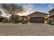 Tuscan style home with a two car garage and paved driveway at 3172 S Mulberry Ct, Gold Canyon, AZ 85118