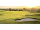 Golf course with sand trap and flag at sunset at 3172 S Mulberry Ct, Gold Canyon, AZ 85118