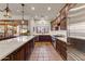 Modern kitchen boasts stainless steel appliances, ample counter space, and terracotta tile floors at 3172 S Mulberry Ct, Gold Canyon, AZ 85118