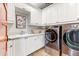 Laundry room with white cabinets, LG washer and dryer at 3172 S Mulberry Ct, Gold Canyon, AZ 85118