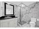 Bathroom features marble tile, a glass shower, and modern vanity at 3609 W Griswold Rd, Phoenix, AZ 85051