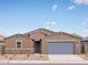 Single-story home with a two-car garage and desert landscaping at 3650 E Alexander Dr, San Tan Valley, AZ 85143