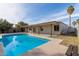 Home with a kidney shaped pool and covered patio at 3801 W Mercer Ln, Phoenix, AZ 85029