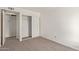 Simple bedroom with carpet, closet, and access to hallway at 3801 W Mercer Ln, Phoenix, AZ 85029