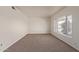 Bright living room with neutral carpeting and large window at 3801 W Mercer Ln, Phoenix, AZ 85029