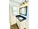 Modern bathroom vanity with dark countertop and black fixtures at 4246 N 11Th Pl, Phoenix, AZ 85014