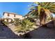 Landscaped backyard with mature palm trees and gravel at 45707 W Barbara Ln, Maricopa, AZ 85139