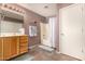 Clean bathroom with shower/tub combo and wood vanity at 45707 W Barbara Ln, Maricopa, AZ 85139