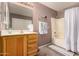 Neat bathroom, shower/tub combo, wood vanity at 45707 W Barbara Ln, Maricopa, AZ 85139